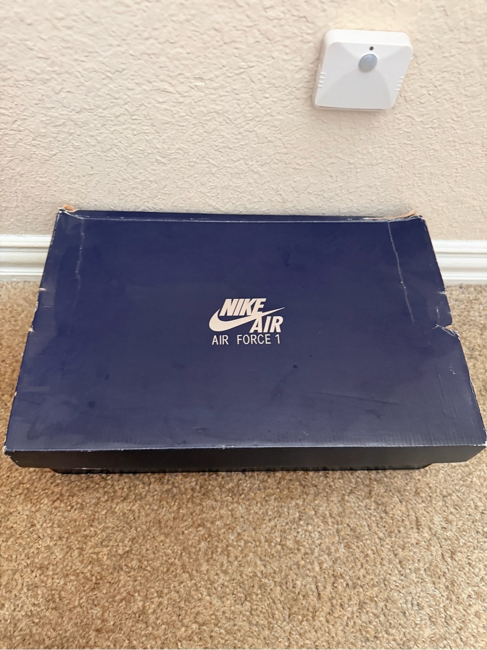 Shoebox on floor under wall sensor